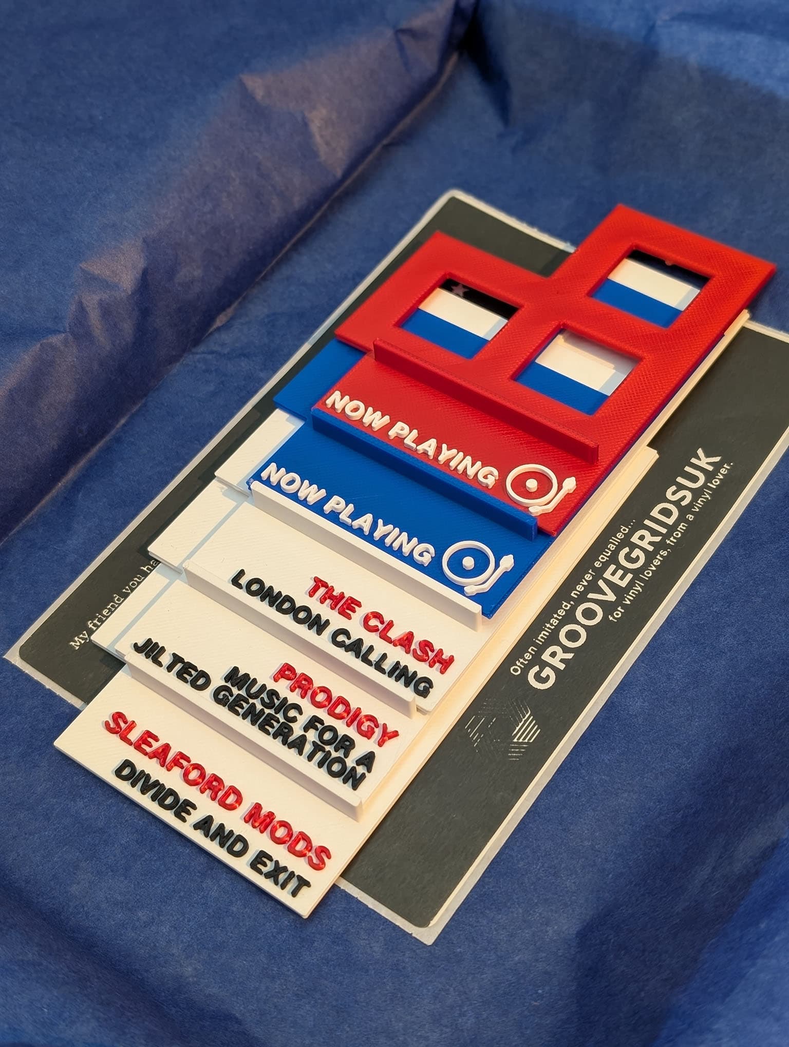 Custom GrooveGrids vinyl record divider in a record collection